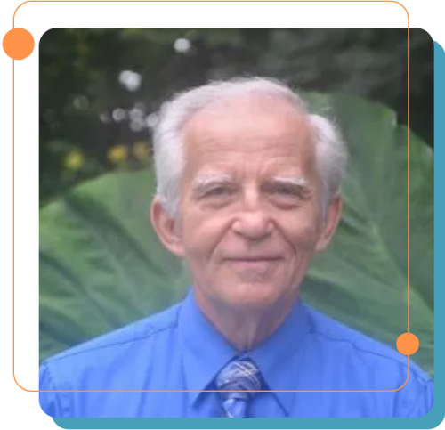 A man in blue shirt and tie with plants